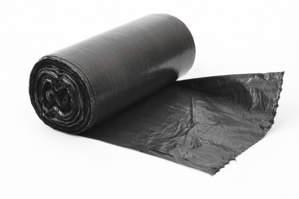 roll of black dustbin liners isolated on white background