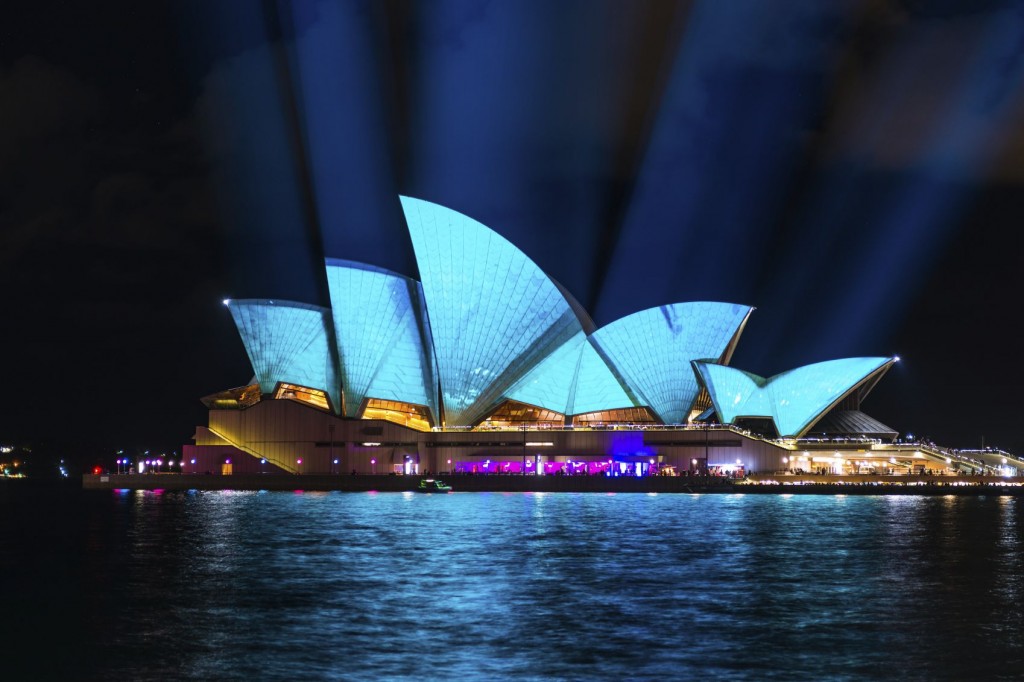 Sydney opera house at night with lights illuminating the sky