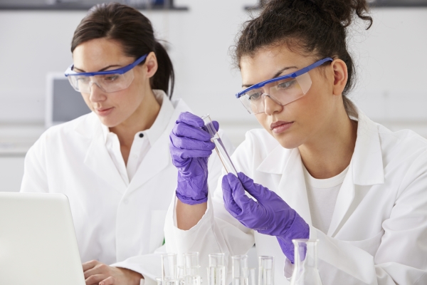 Two female scientists analysing sample data