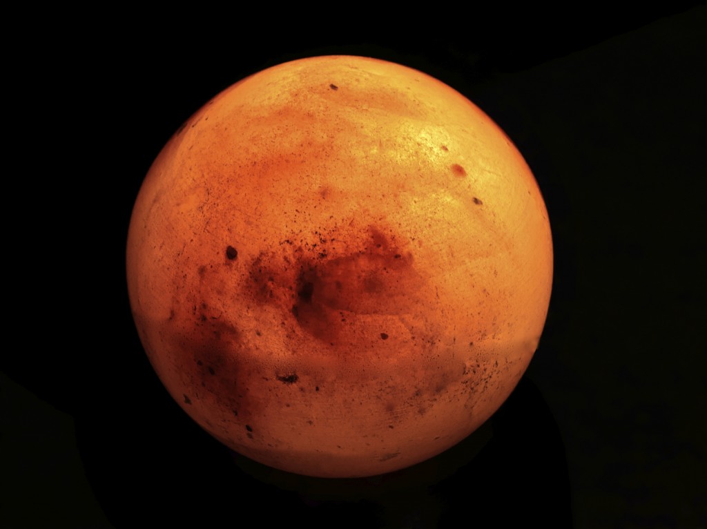 Mars as it appears in the sky through a telescope from earth