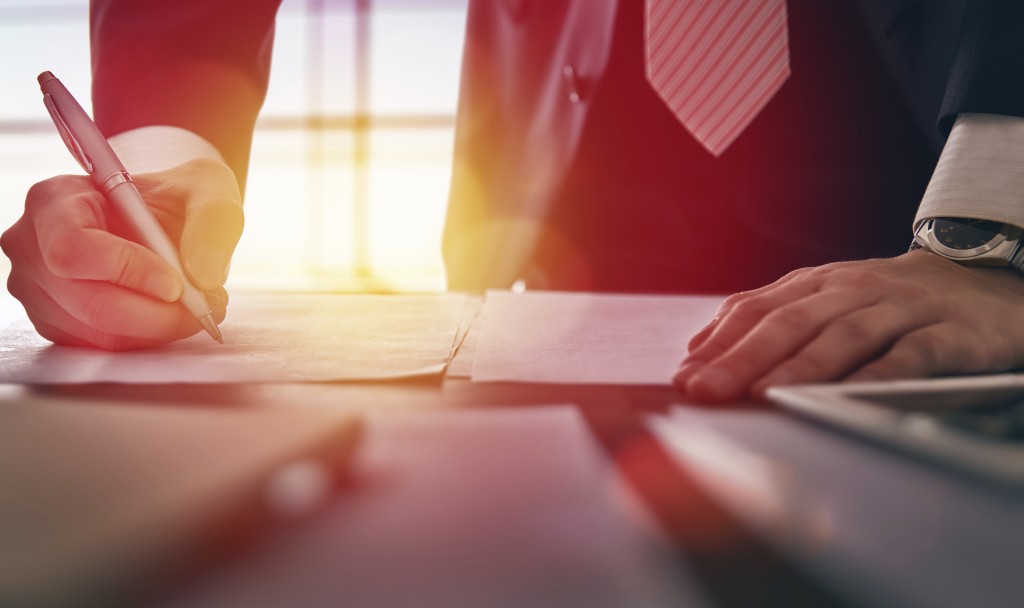 businessman signing documents