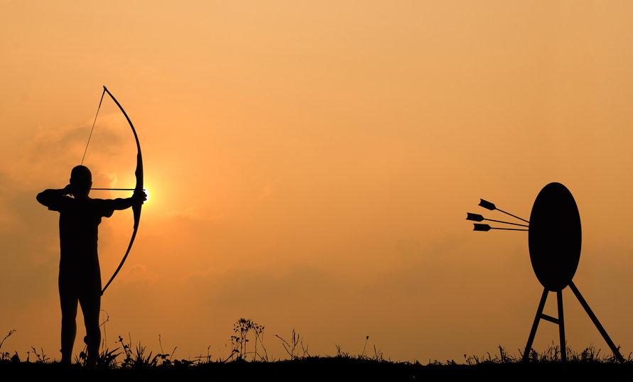 Silhouette archery shoots a bow at the target