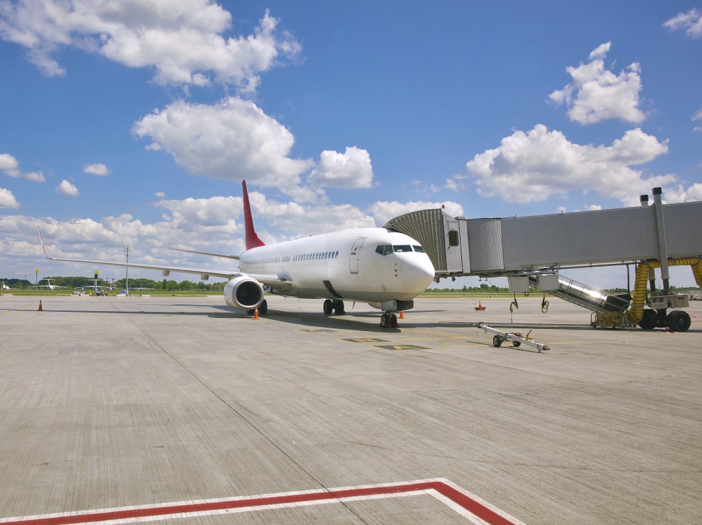 Passenger jet plane standing at the terminal gate