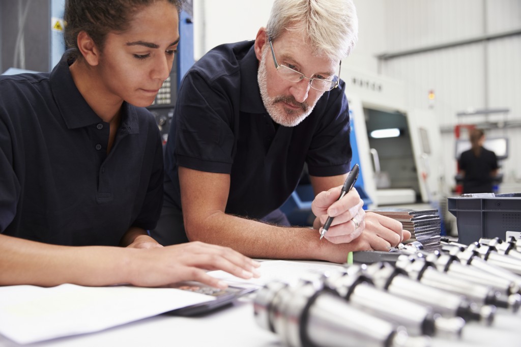 Engineer And Apprentice Planning CNC Machinery Project