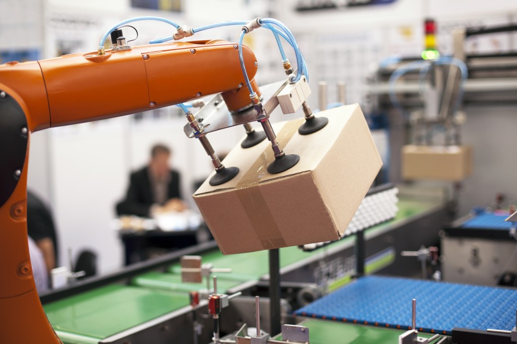 Packaging line with robotic arm at work