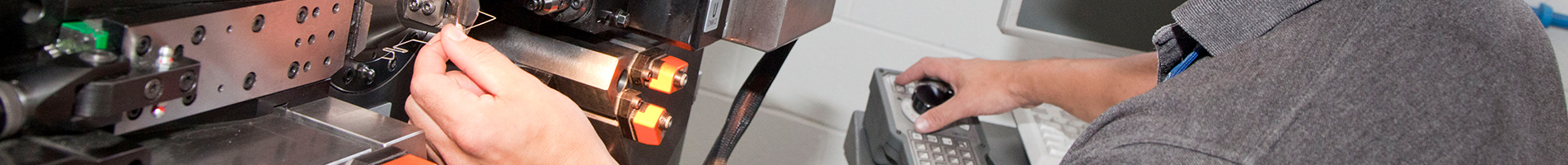 man operating cnc machine in banner image