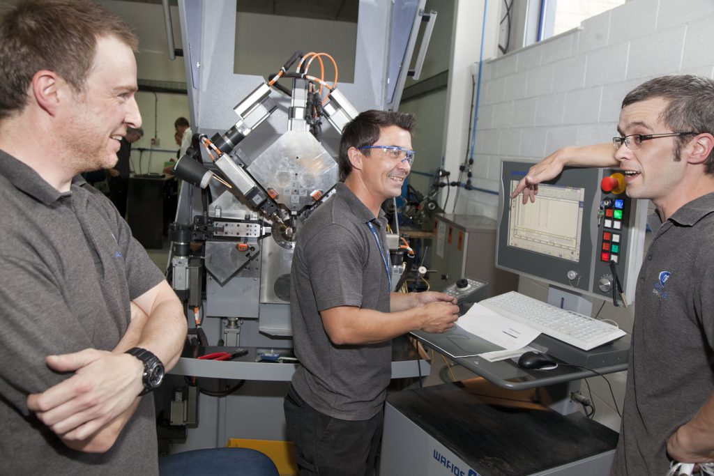 Happy Airedale Springs Staff working with industrial machines