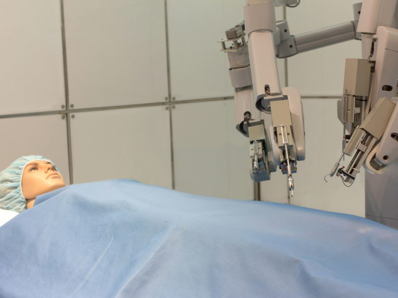 a surgical robot undertaking a test on a plastic doll patient