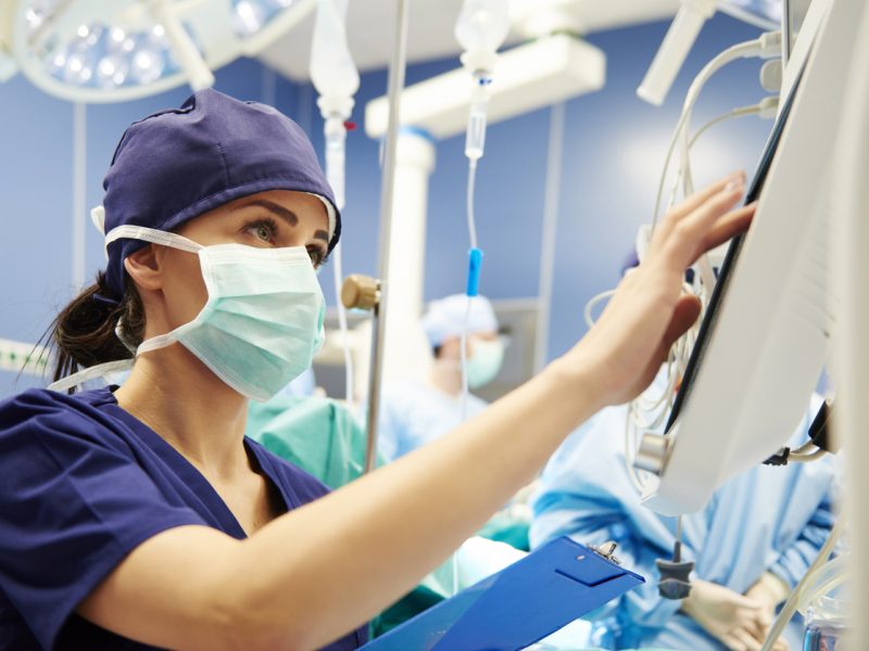 Nurse working with technology in operating room