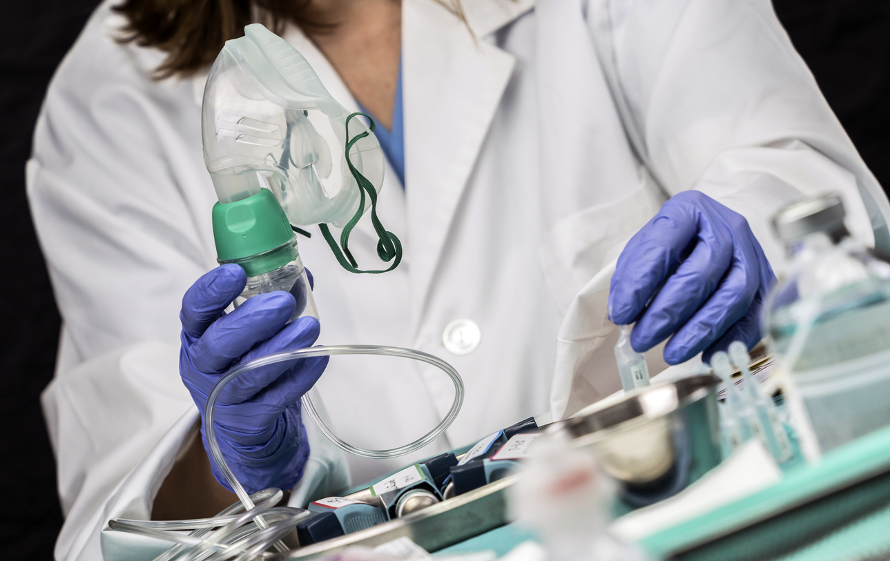 Nurse prepares oxygen mask in hospital