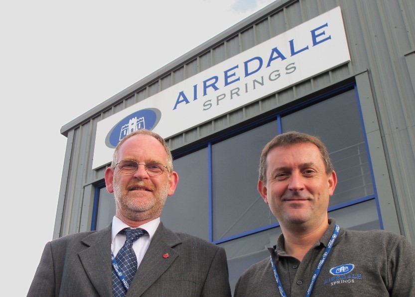 Airedale springs chairman and colleague stood outside manufacturing facility