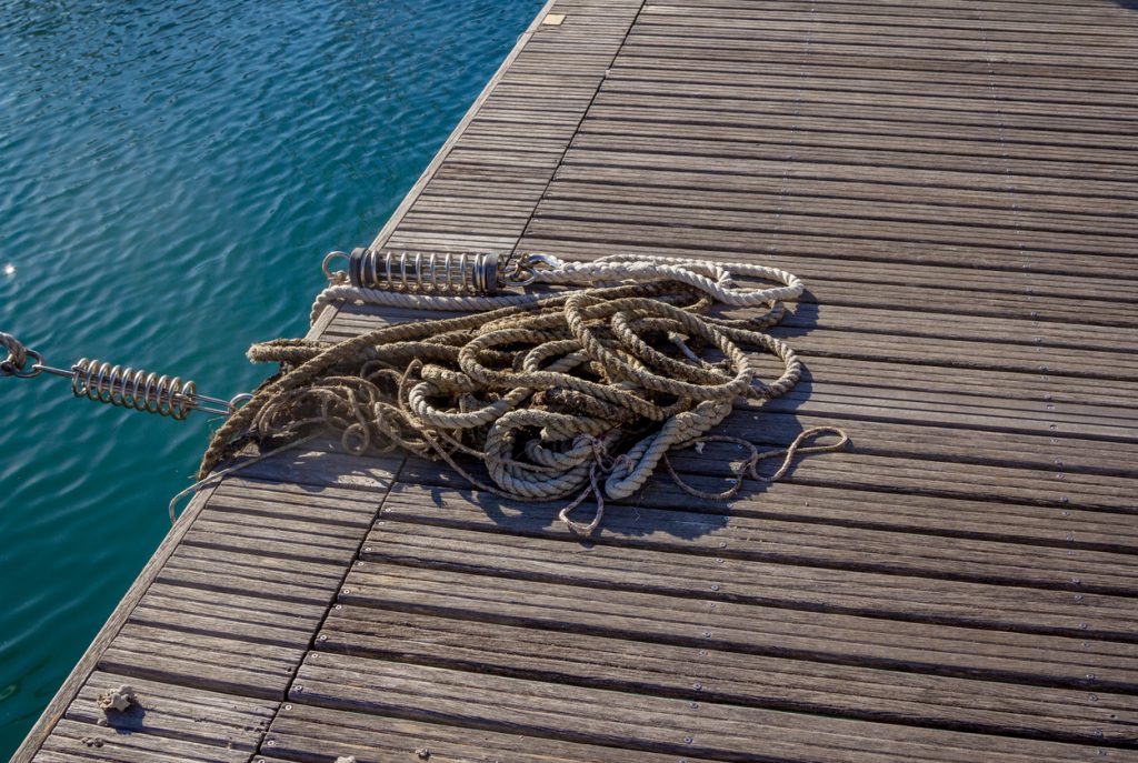 Mooring and seafaring ropes for boat anchoring on wooden ferry deck