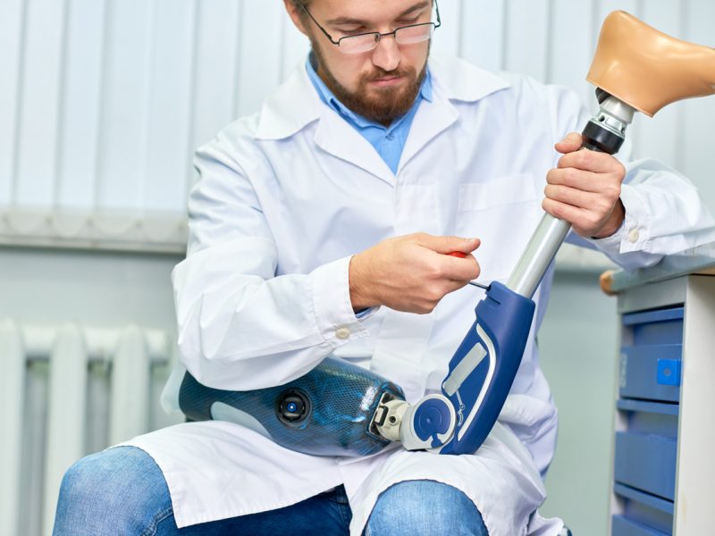 Doctor Assembling Prosthetic Leg