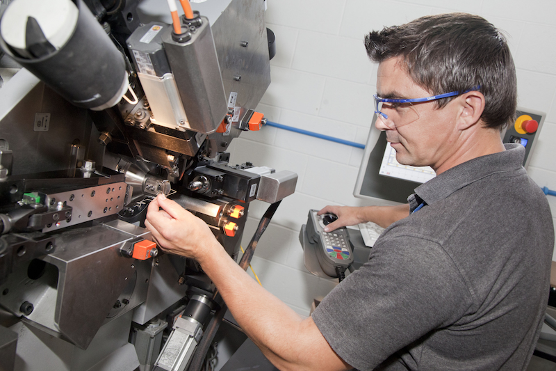 person making spring for electronics