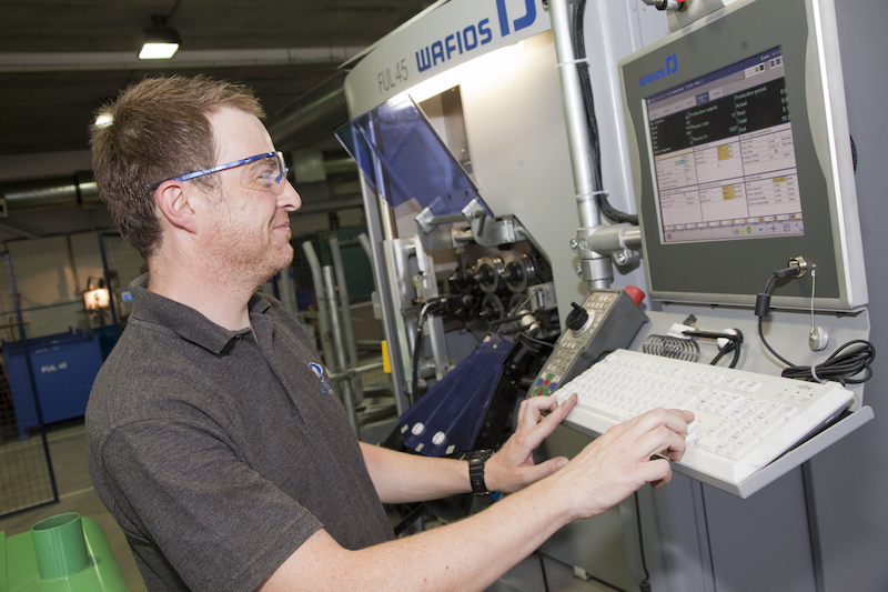 engineer operating CNC machine