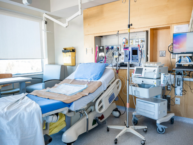 A hospital room with a bed and medical equipment